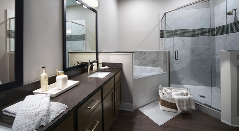 a bathroom with a glass shower stall