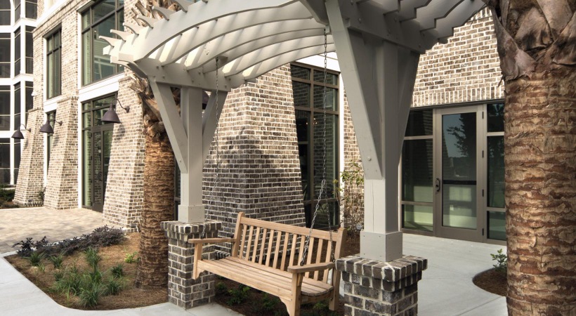 a swinging bench in front of a building