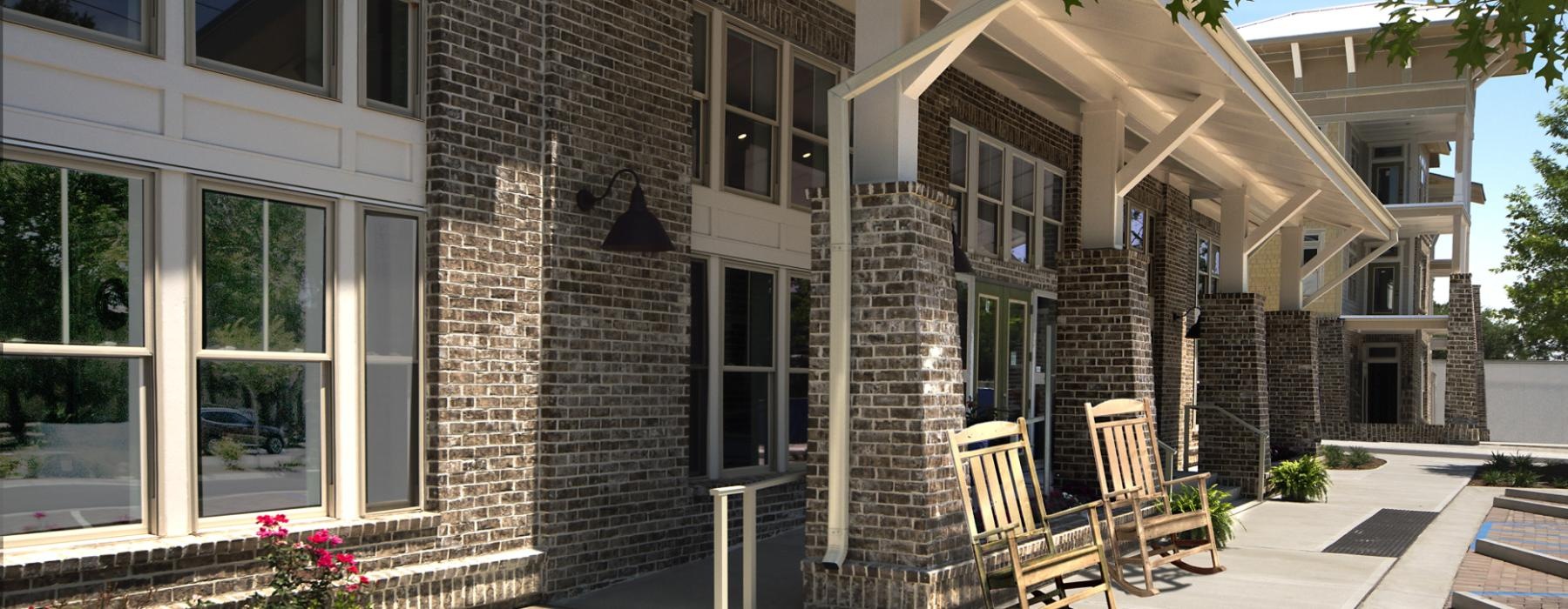 a building with rocking chairs outside