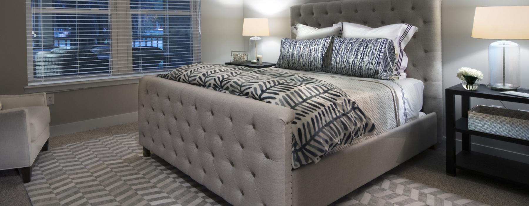 a bedroom with a bed and windows