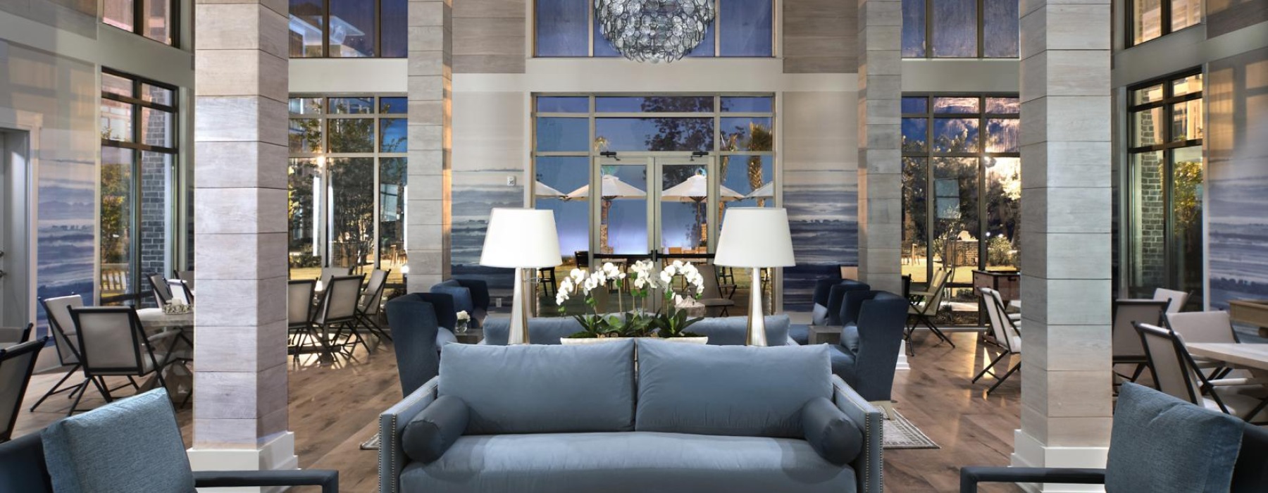 a large room with a large chandelier and a couch