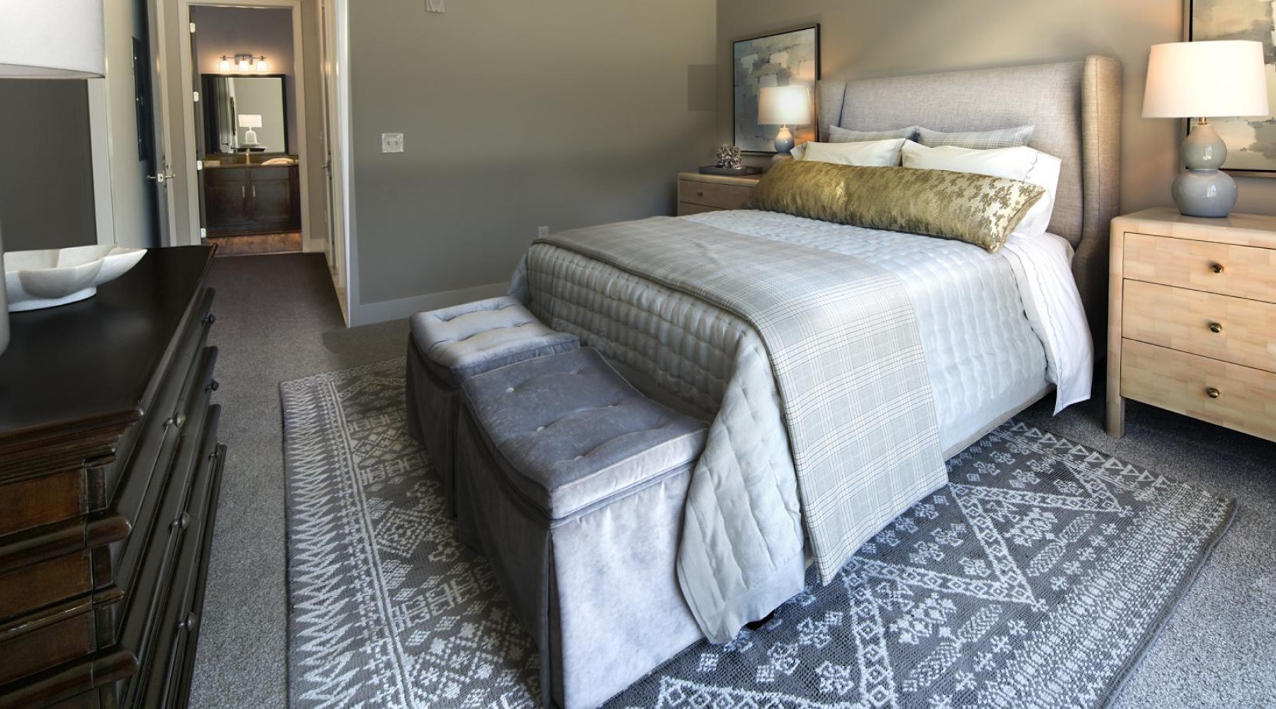 a bedroom with a bed and a bench