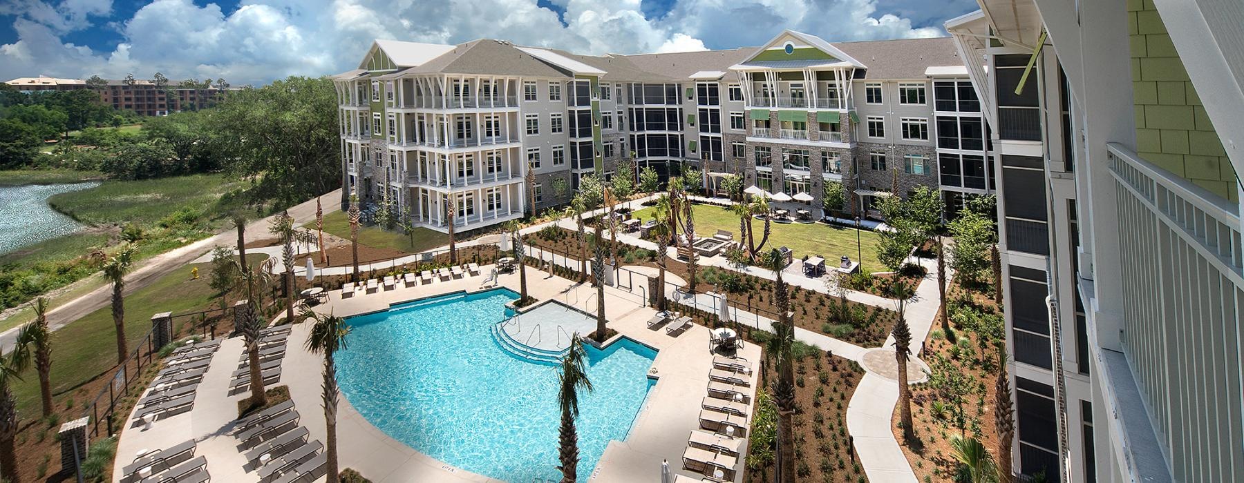 a pool in a courtyard with buildings around it