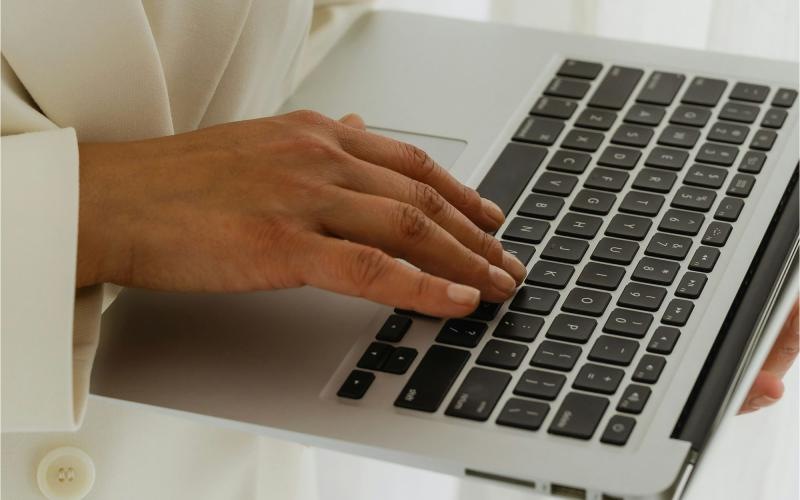 a person typing on a laptop
